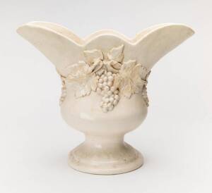 An Australian pottery vase attributed to Una Deerbon, of white glazed flared grape vine design, 31cm high