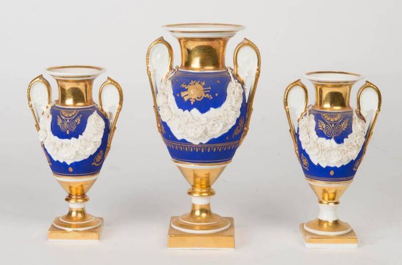 A French Empire porcelain three piece urn garniture, 19th Century. Largest 25cm high