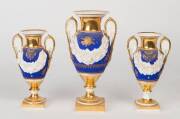 A French Empire porcelain three piece urn garniture, 19th Century. Largest 25cm high