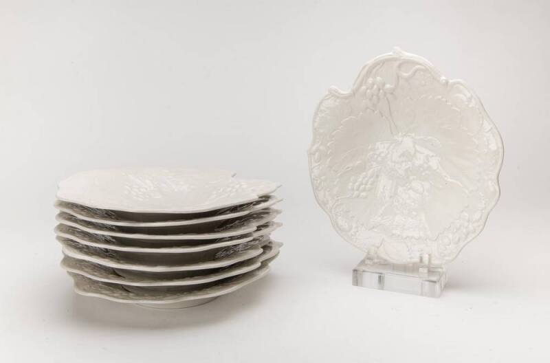 A set of eight white English porcelain grape patterned plates. 21cm diameter.