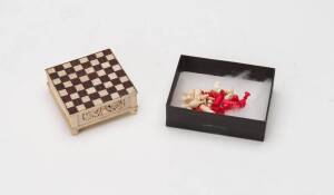 Anglo- Indian carved & coloured ivory miniature chess set, mid 19th Century. 6cm square, 2cm high.&nbsp;