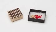 Anglo- Indian carved & coloured ivory miniature chess set, mid 19th Century. 6cm square, 2cm high.&nbsp;