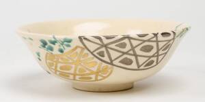 A yellow painted Japanese bowl in wooden box
