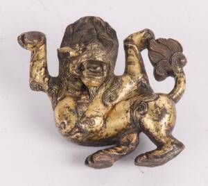 A small parcel gilt bronze Tibetan snow lion, 16th/17th century