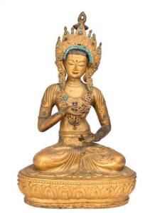 A Tibetan gilt bronze repousse seated Buddha with semi-precious stones inlaid, 20th century. High 50cm.