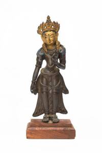 A Nepalese bronze standing Buddha with painted gold on the face, 20th century. High of the Buddha 30.5 cm