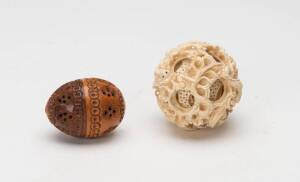Chinese carved ivory puzzle ball (6cm), & a 19th Century carved coquilla nut (5cm). 2 items&nbsp;