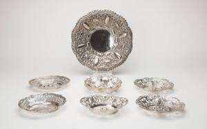 Indian silver circular bowl & 7 Israeli silver oval pierced bowls. The Indian bowl embossed with elephants, 29cm diameter; the oval bowls embossed with fruit & floral decoration, one 30 x 25cm and 6 approx. 18 x 14cm, approx. 1,500 grams