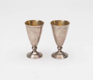A pair of silver vodka cups, stamped 911. Early to mid 20th Century. 7cm.&nbsp;