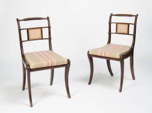 A pair beech stained regency sabre legged chairs with cane seat & insert to back