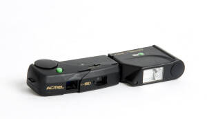 ASANUMA (Japan): Acmel MD, cira 1986 sub-miniature camera for 8.5x11mm exposures on Minox cassettes (one present) with detachable MDX electronic flash, chain, carry bag and batteries in maker's presentation box.