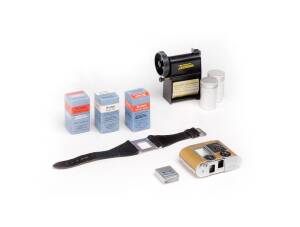 CONCAVA (Switzerland): Tessina automatic 35 in gold [#665117], with slip-on meter, brown leather case with gold trim, maker's box, wrist strap and 2 cassettes, Tessina daylight loader in original plastic case. Also, 3 boxes of Kodak film for Tessina: Ekta