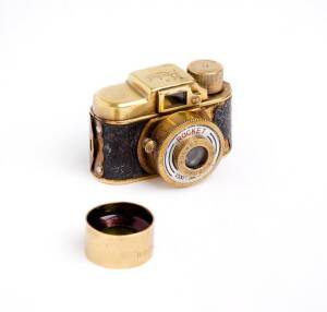 ROCKET CAMERA CO. (Japan): New Rocket, c1946-49, sub-miniature camera in gold metal, this version with "Rocket Camera Co. Ltd" near lens