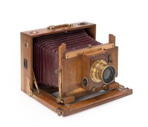 An attractive timber and brass folding field camera.