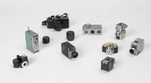A group of subminiature cameras. The group comprising a Coronet Midget, Whittaker Micro 16 and Pixie, Universal Minute 16, Tynar, Arrow, Top, Steky Model III, and a Pentax auto 110 with 18, 24, and 50mm lenses. (9 cameras)