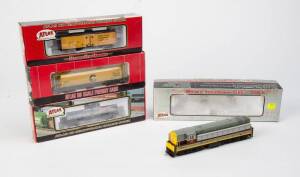 ATLAS: Train Master Locomotive (Erie Lackawanna) together with rolling stock comrising 36' Wood Reefer Car (Nickel Plate), 6 Bay Cylindrical Hopper (Chessie) & 11,000 Gallon Tank Car (Fuelane Corp.). All NIB. (4 items).