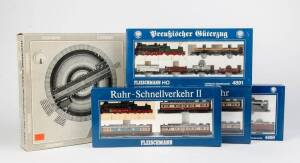 FLEISCHMANN HO sets in original boxes, comprising #4887, 4888, 4891 & 4899; together with an Electric turntable #6652. (5 items).