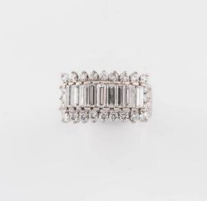 A diamond ring, set with nine baguette and twenty-four round brilliant diamonds, estimated total diamond weight 2 carats, 18ct white gold, size K &frac12;, marked 18k, weight 7.35 grams.