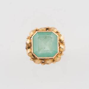 An emerald ring, the square emerald set in a foliate frame, 14ct yellow gold, weight 6.80 grams, size K &frac12;.