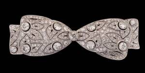 An Edwardian diamond bow brooch, estimated diamond weight 7.28 carats, platinum,&nbsp;length 7.9cm.
