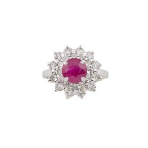 A ruby and diamond cluster ring, the central round ruby of weight 1.67 carats, surrounded by round brilliant diamonds,18ct white gold, size M.&nbsp;