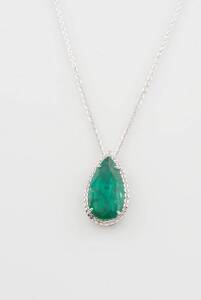 An emerald and diamond pendant, the pear shaped emerald of known weight 6.70 carats, surrounded by diamonds of total weight 0.35 carat, 18ct white gold.