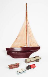 Pond yacht, jarrah canoe, Dinky toy caravan, toy truck, tin plate racing car by "Prestyn" & a "Boomerang" tin plate tram. (6 items)