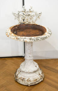A white painted cast iron circular bird bath with two birds & leaf cresting, 88cm high, & a 4 tier water-lily plant stand, 56cm high