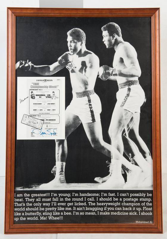 MUHAMMAD ALI & LEON SPINKS, signatures on reprinted flyer, window mounted with b/w photograph of Ali, framed & glazed, overall 66x91cm.