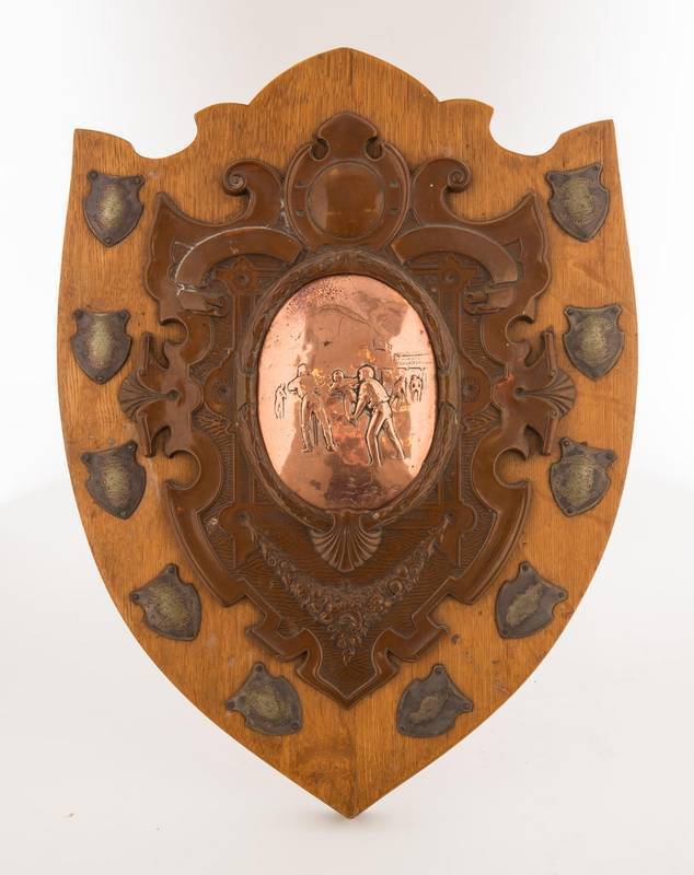 TOBACCO COMPANIES PERPETUAL SHIELD, with central vignette of cricket match in copper (well worn after a century of polishing), surrounded by shields for winners 1909-21 (break for WW1). Winners - Sydney (2), Melbourne (3) & NSW (3). Made by Hardy Bros, Sy