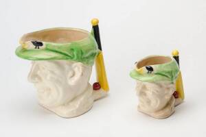 DON BRADMAN TOBY JUGS, 10cm high & 15cm high (handle repaired), both with cap in green, made by Marutomo Ware, 1934. 