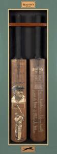 DON BRADMAN, display "The Bradman Record 1927-1949", comprising two full size Cricket Bats, one signed, with two painted portraits by Dave Thomas; other printed on front with Bradman’s playing statistics. Mounted in attractive display case, overall 50x114