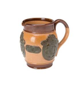 Royal Doulton Lambeth jug with applied NZ Tiki motives 1905-23, Lion & Crown backstamp, 8cm tall.