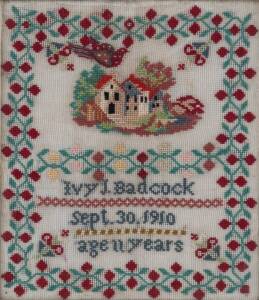 A needlework sampler by Ivy Badcock, Tasmania 1910, with original frame. 47cmx 41.5cm