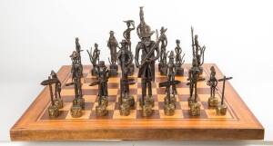 Australiana bronze chess set circa 1960s with Bushrangers verses Aboriginals. With accompanying inlayed timber folding games table. Tallest 29.5cm.