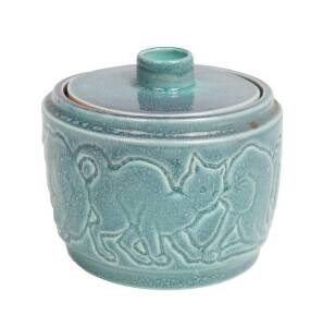 KLYTIE PATE Pottery lidded jar with sgraffito car motif, glazed in blue & mauve. Height 10cm, width 12cm