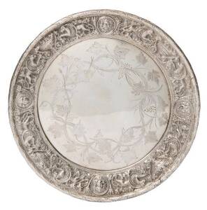 An Australian silver tray by William Edwards of Melbourne, circa 1865, engraved with scrolling grapevines within a cast border of classical masks, mythical beasts & grape filled urns, marked "W.EDWARDS/MELBOURNE" 23.5cm diameter, 530 grams. For a similar 