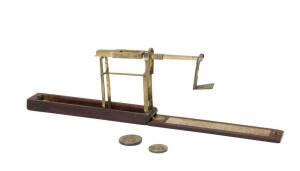 An English pocket weighing instrument for checking the weight of guinea and half guinea gold coins. Made by "A. Wilkson late of Kirky near Liverpool" together with a guinea and half guinea coin weights . Both stamped with a crown. Circa early 18th Century