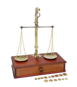 Gold bullion balance scales mounted on cedar single drawer base, scales stamped in 1863 with two sets of weights, one in Troy ounces (0.1 to 0.5oz Troy all stamped in 1855 at the Old Melbourne Observatory) & a rare set of currency weights denominated in s