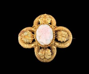 A gold foliate and cameo quatrefoil brooch, attributed to Fischer, Geelong.  The carved conch shell depicting a classical female profile within a vine leaf and tendril mount.  Yellow gold, length 45mm.