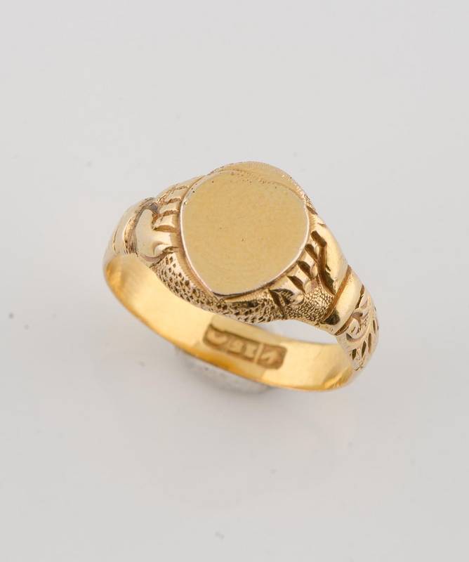 A gold signet ring by Macrow & Sons, Melbourne, carved shoulders with hand motif, Impressed three part bar mark, thistle, 15 and hanging fleece. Weight 4.42 grams. Size M ½.