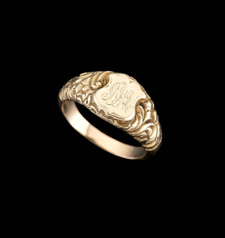 A gentleman s signet ring circa 1850 s carved shoulders and initialled shield. Yellow gold faux English hallmarks