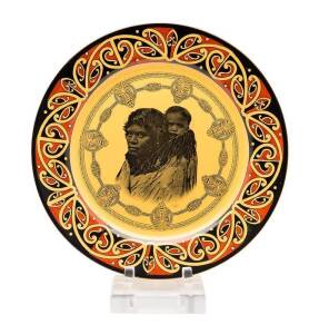 Royal Doulton Maori Woman & Child Plate, with Maori Art borders, photographic engraving of a woman with a baby on her back, designed 1929, backstamp Lion & Crown.
