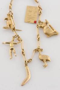 A gold Australiana charm bracelet, the fancy link bracelet hung with six charms, an emu, a kangaroo, a boomerang, a koala, an aboriginal figure with boomerang, and an envelope. 18ct yellow gold. Weight 18.34 grams.