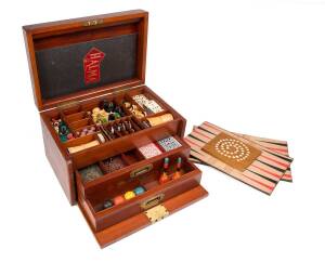 A Victorian mahogany games box including bone and ebony dominos, chess, cards, draughts, backgammon, croquet, horse racing etc. Provenance: George Lansell Collection Bendigo from the Fortuna mansion, by direct family descent. 24cm high, 27cm deep, 39cm wi