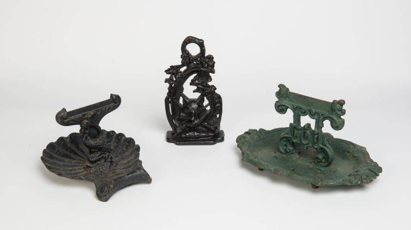 Two Victorian cast iron boot scrapers & a door stop. The doorstop 29cm high