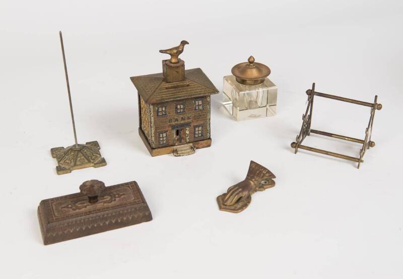 A group of antique desk ware comprising paperweight, bill spike, ink pot, paper clip, pen holder & cast iron bank. 