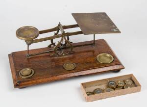 Postage scales & weight (15), English, brass on oak base, 19th Century. Plus 2 boxed sets of weights (one incomplete). 15cm high, 38cm wide, 19cm deep