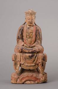 A Chinese polychrome wood figure, circa 17th Centuryseated in lotus posture on a draped waisted pedestal, with an open aperture at the back, traces of gilt, red and black pigments36.5cm highProvenanceA private NSW collection