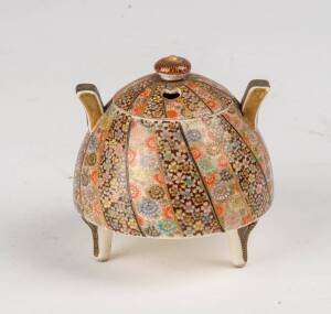 A small Japanese satsuma tripod censer, decorated with vertical bands of floral designs. 7cm high.